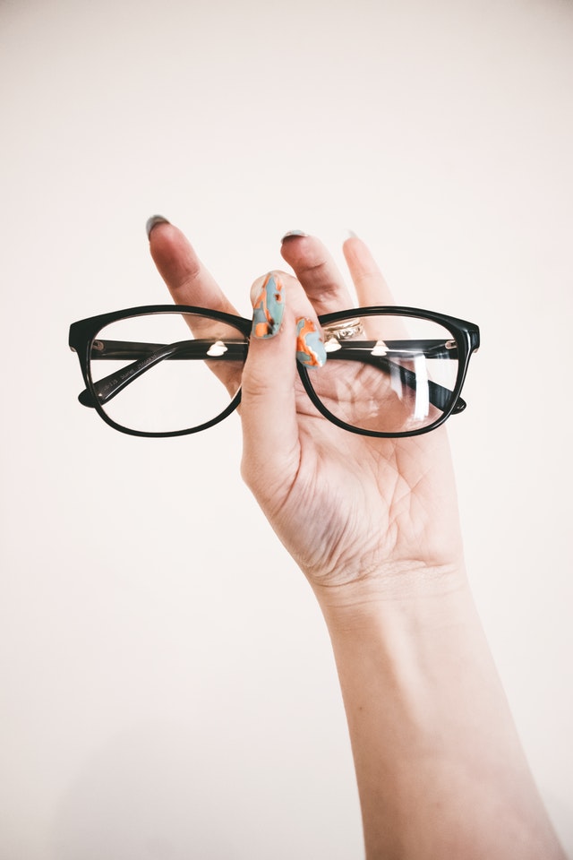 photo of person holding eyeglasses 1068866
