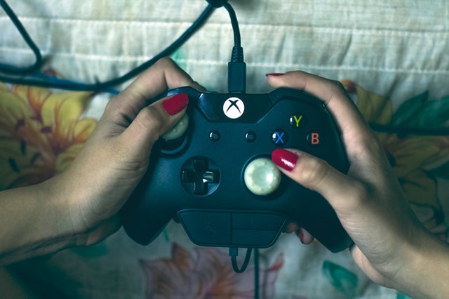 person holding microsoft xbox one controller 1666759